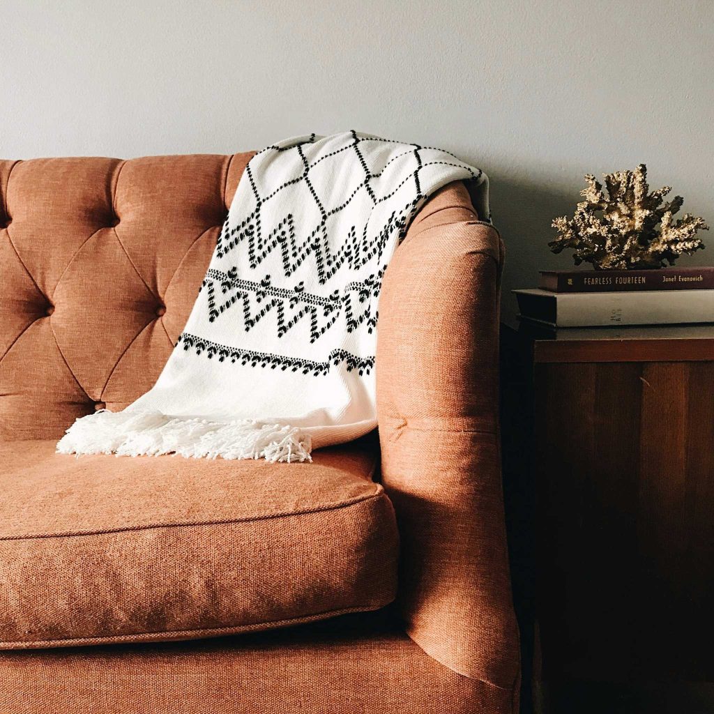 Comfy sofa with blanket.